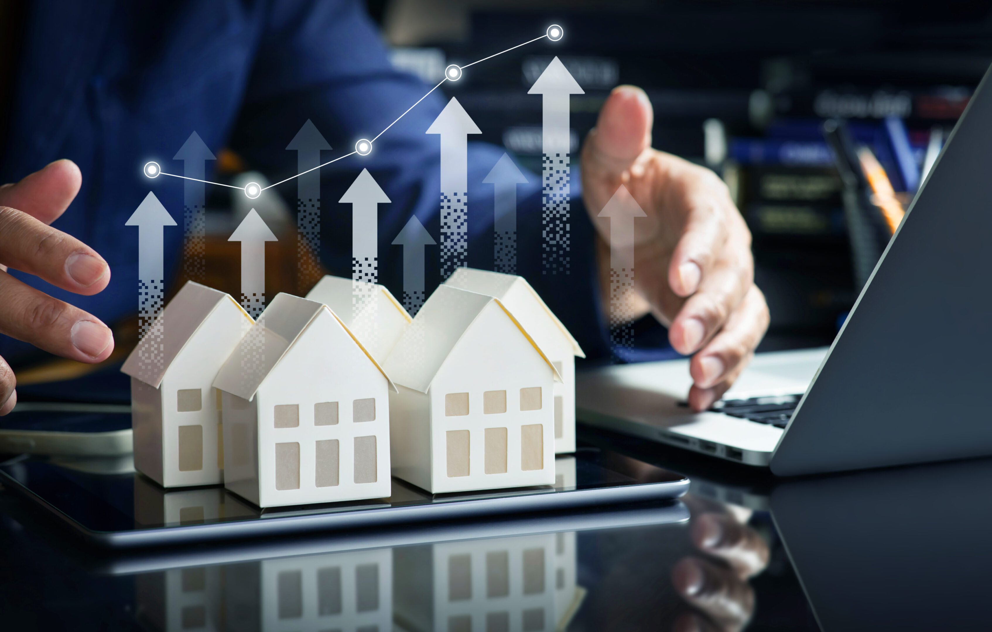 Rising real estate market concept with arrows.